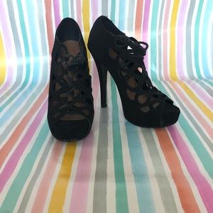 Black high heels with cutouts lace up in the front